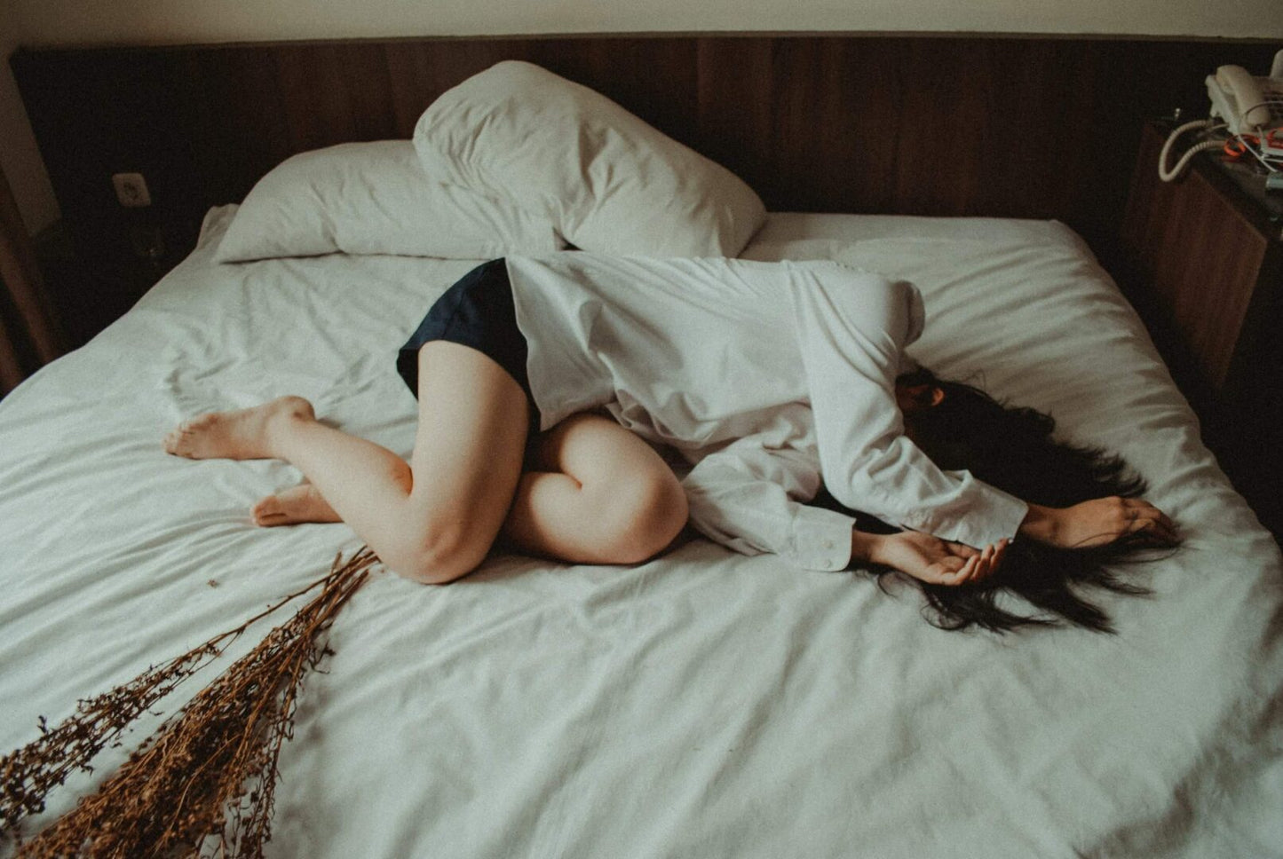 A woman laying on the bed with her legs spread open.